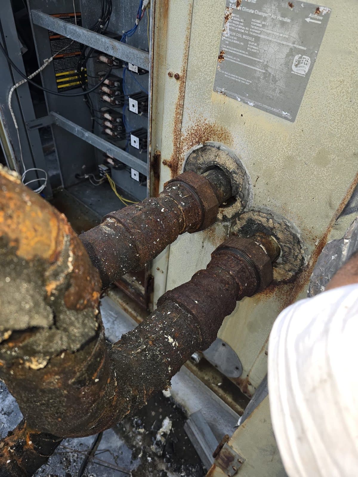 Before — chilled-water connections scaled and rotted at the cabinet