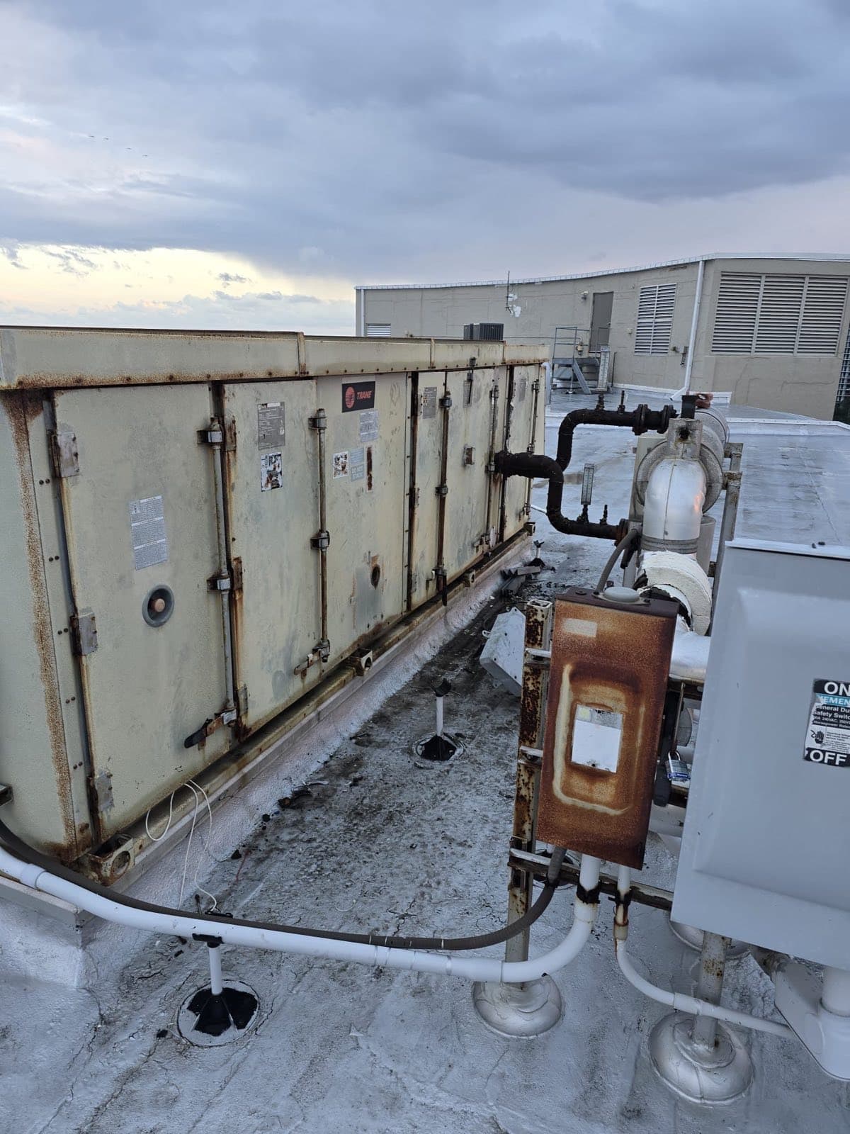 Before — corroded disconnect and sagging condensate lines