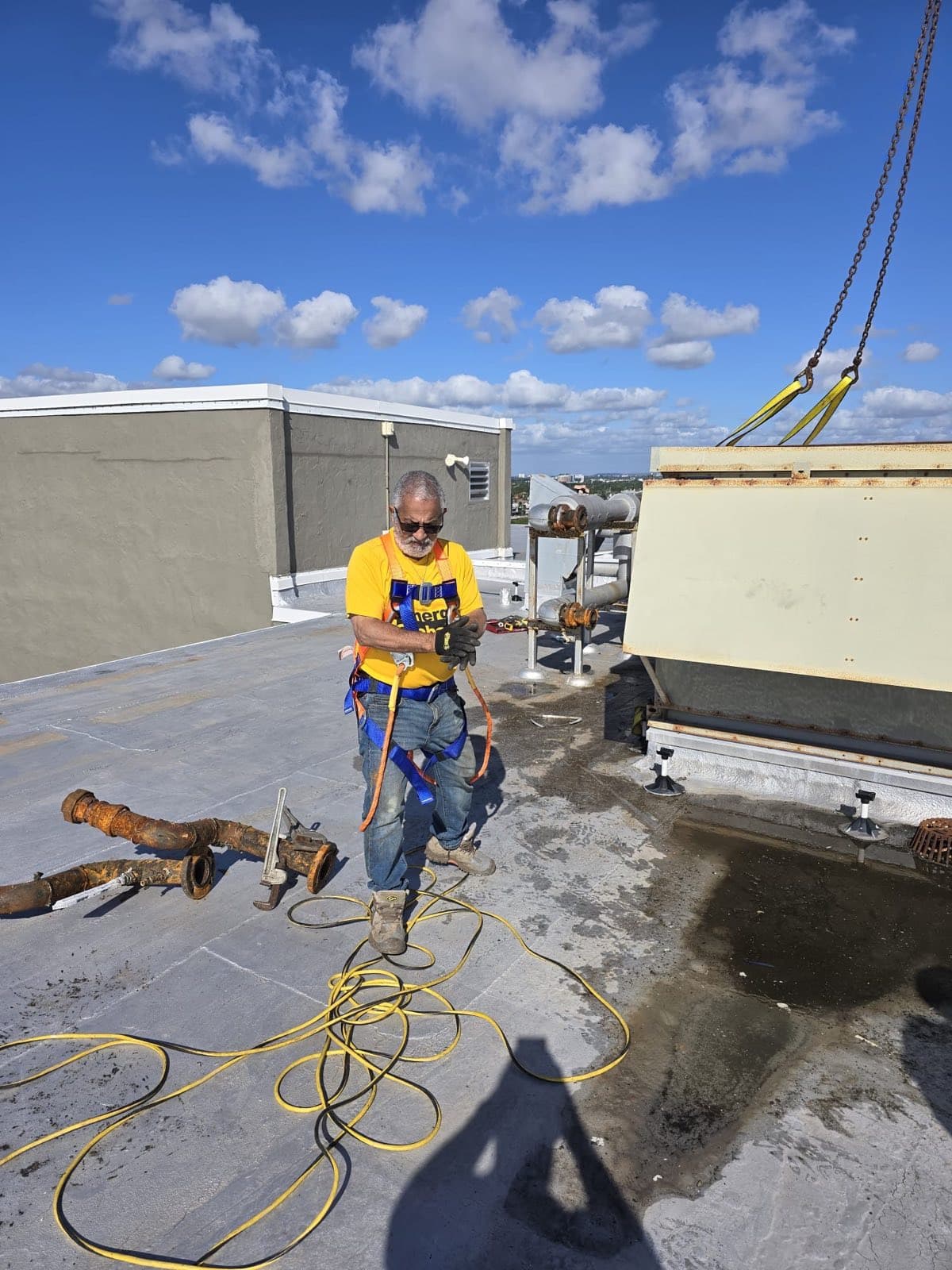 Demolition — old piping cut out and staged on the roof